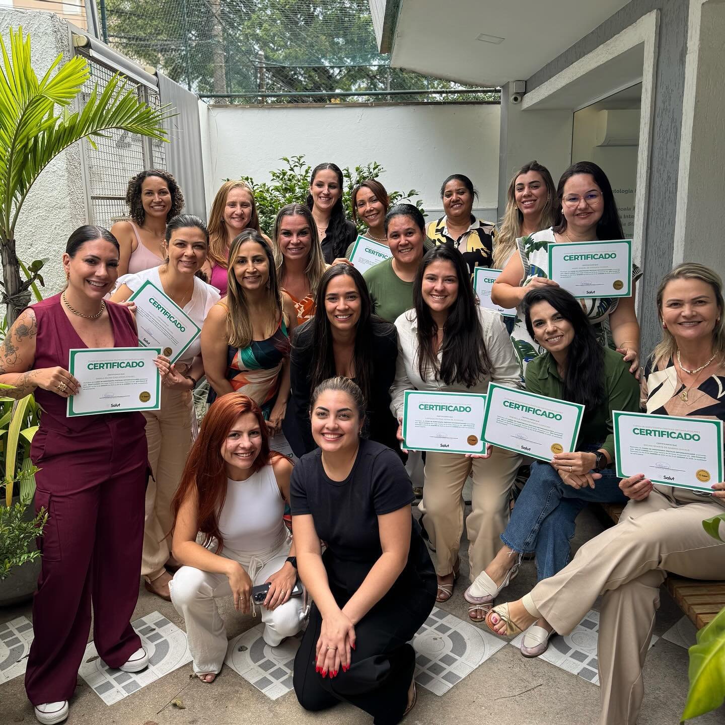 Turma formada no pátio segurando os certificados Salut